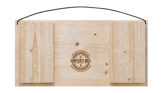 Back of Sawyer's Mill 7 x 14 pine sign showing wood construction, branding, and attached wire hanger.