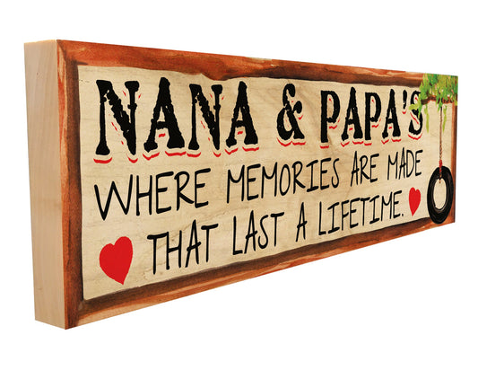 Side view of rustic maple wood sign with text: "Nana & Papa's – Where Memories Are Made That Last a Lifetime" with red hearts and a tire swing
