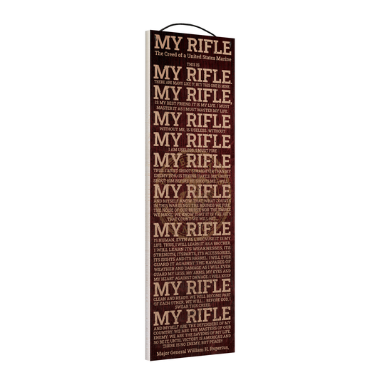 Angled view of the My Rifle Marine Creed 5 x 16 wood sign, showing the board thickness and wire hanger