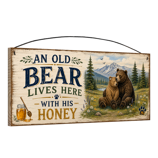 Angled view of the Old Bear and His Honey Mountain 7 x 16 pine wood sign showing the board edge and hanging wire