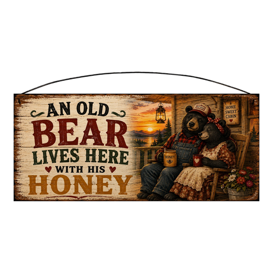 An Old Bear Lives Here With His Honey 7 × 16 pine wood sign — black bear couple on a cabin porch at sunset