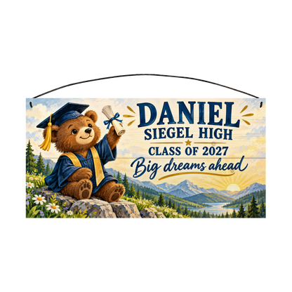 Personalized Big Dreams Ahead graduation wood sign, 7 x 14 in — a teddy bear in a navy cap and gown holding up a diploma on a mountain overlook at sunrise