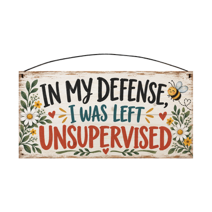 In My Defense I Was Left Unsupervised wood sign, 7 x 14 in, black teal and barn-red brush lettering with daisies and a bumblebee on whitewashed pine