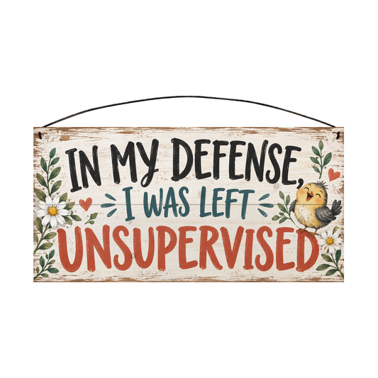 In My Defense I Was Left Unsupervised wood sign, 7 x 14 in, black teal and red-orange brush lettering with a laughing yellow chick and daisies on whitewashed pine
