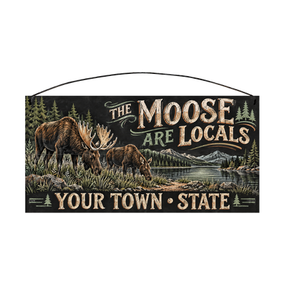 Personalized The Moose Are Locals wood sign, 7 x 14 in — Bull moose and calf grazing by a mountain lake, with your town and state