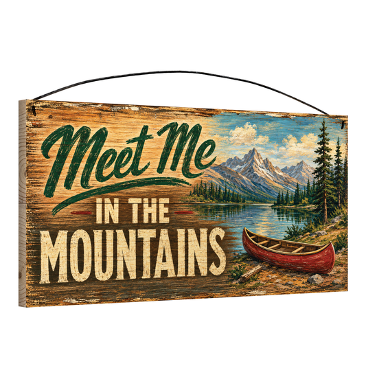 Angled view of the Meet Me in the Mountains 7 x 14 pine wood sign showing the board edge and hanging wire