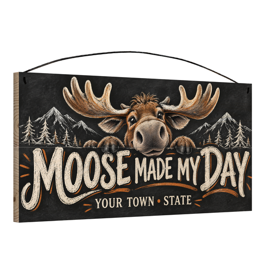 Angled view of the personalized Moose Made My Day 7 x 14 in pine wood sign, showing the board thickness and wire hanger