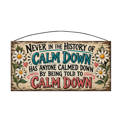 Never in the History of Calm Down wood sign, 7 x 14 in, black, teal and coral lettering between white daisies, whitewashed pine