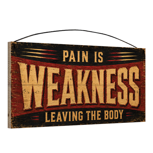 Angled view of the Pain Is Weakness Leaving the Body 7 x 14 pine wood sign showing the board edge and hanging wire