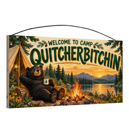 Angled view of Welcome to Camp Quitcherbitchin Lounging Bear wood sign, 7 × 14 in, showing board thickness and wire hanger