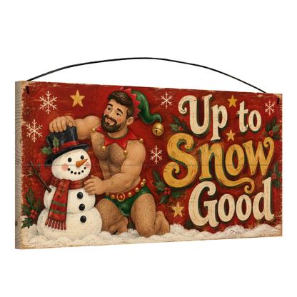 Angled view of the Up to Snow Good Elf and Snowman Wood Sign 7 x 14 pine wood sign showing the board edge and hanging wire