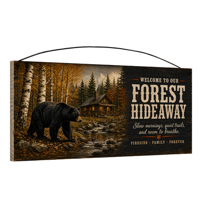 Angled view of the Welcome to Our Forest Hideaway 7 x 16 pine wood sign showing the board edge and hanging wire