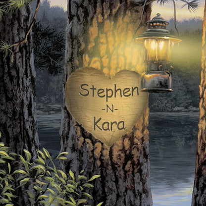 This close-up detail of the custom print shows the heart carved into the tree, softly lit by a lantern — it’s a romantic and personal touch in a lakeside setting.