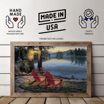 A personalized lake art print showing a peaceful lakeside scene at dusk, with two Adirondack chairs facing the water and a tree carving of a heart with custom couple names softly lit by a gas lantern.