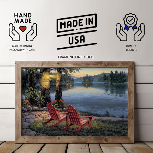 A personalized lake art print showing a peaceful lakeside scene at dusk, with two Adirondack chairs facing the water and a tree carving of a heart with custom couple names softly lit by a gas lantern.