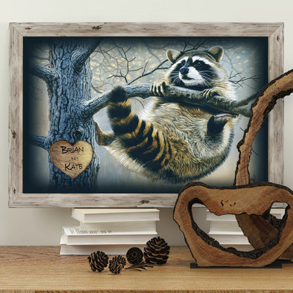 This artwork shows a raccoon clinging to a tree limb, with a heart shape carved into the tree, personalized with two names.