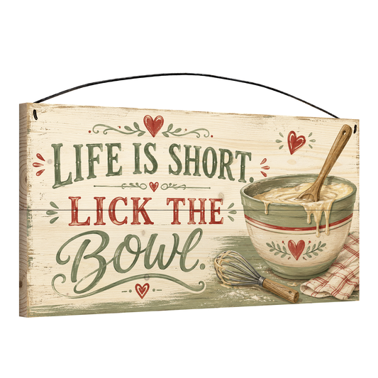 Angled view of the Life Is Short Lick the Bowl sage green 7 x 14 pine wood sign showing the board edge and hanging wire